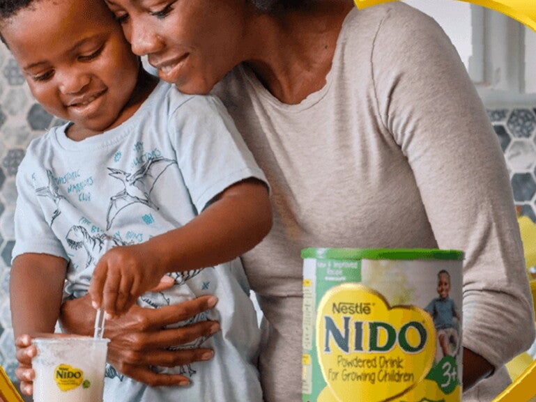 Nido 3 plus in a kitchen with a mum and her son preparing this product.